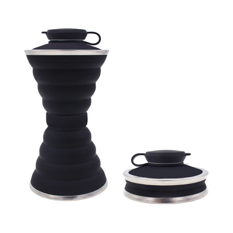 Black collapsible bottle with silver base and lid on a white background