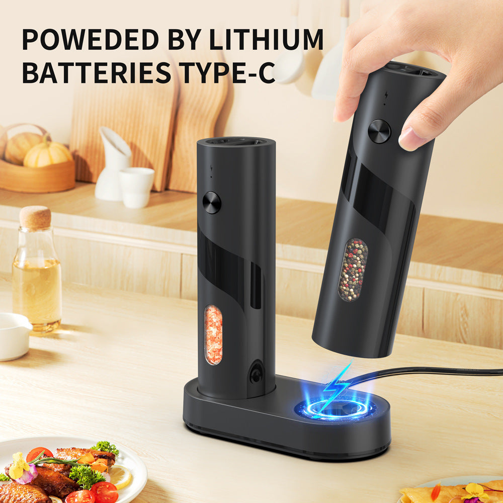 Black electric pepper grinder with charging station on a kitchen counter, text 'Powered by Lithium Batteries Type-C'.
