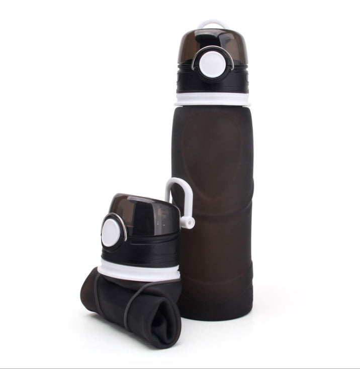 Collapsible black water bottle with white accents on a white background