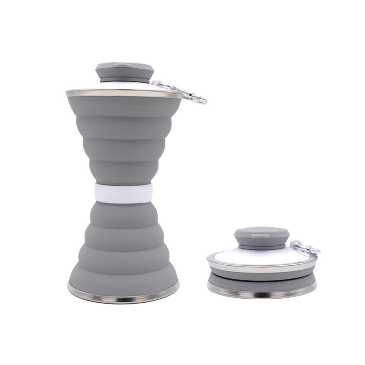 Collapsible gray silicone bottle with white accents on a white background
