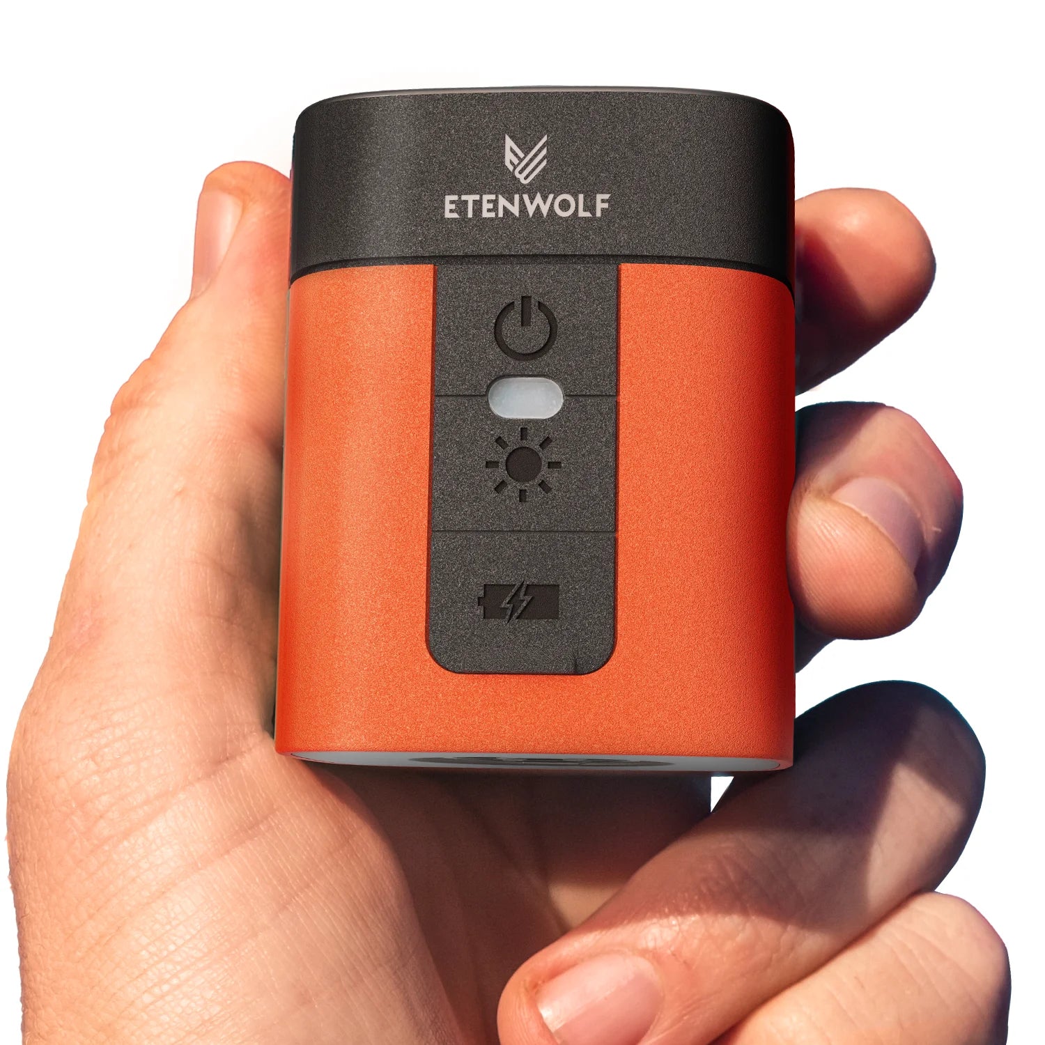 Hand holding a small orange and black device with 'Etenwolf' branding.