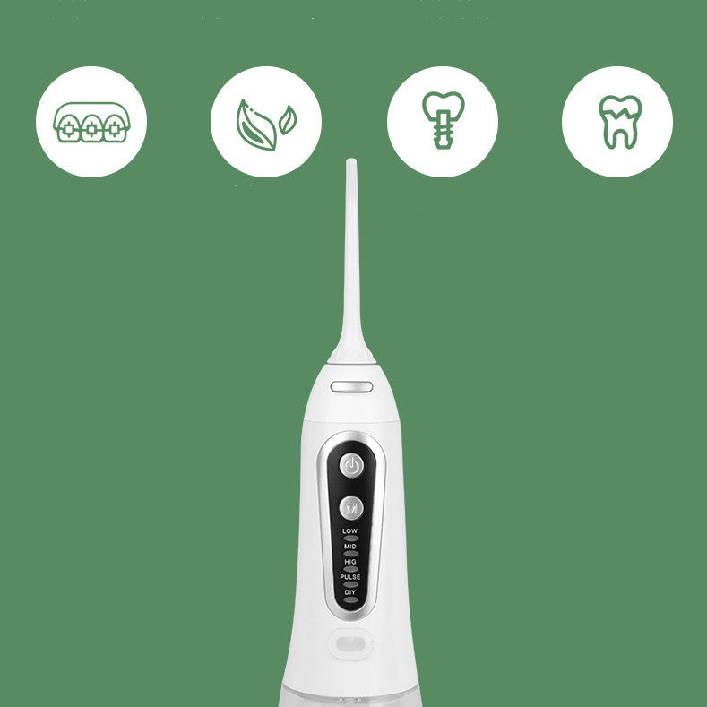 White dental water flosser with control buttons on a green background
