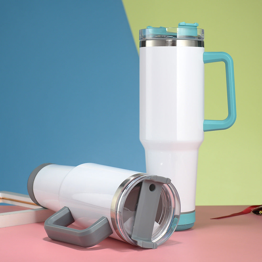 White insulated travel mug with blue handle and accents on a colorful background